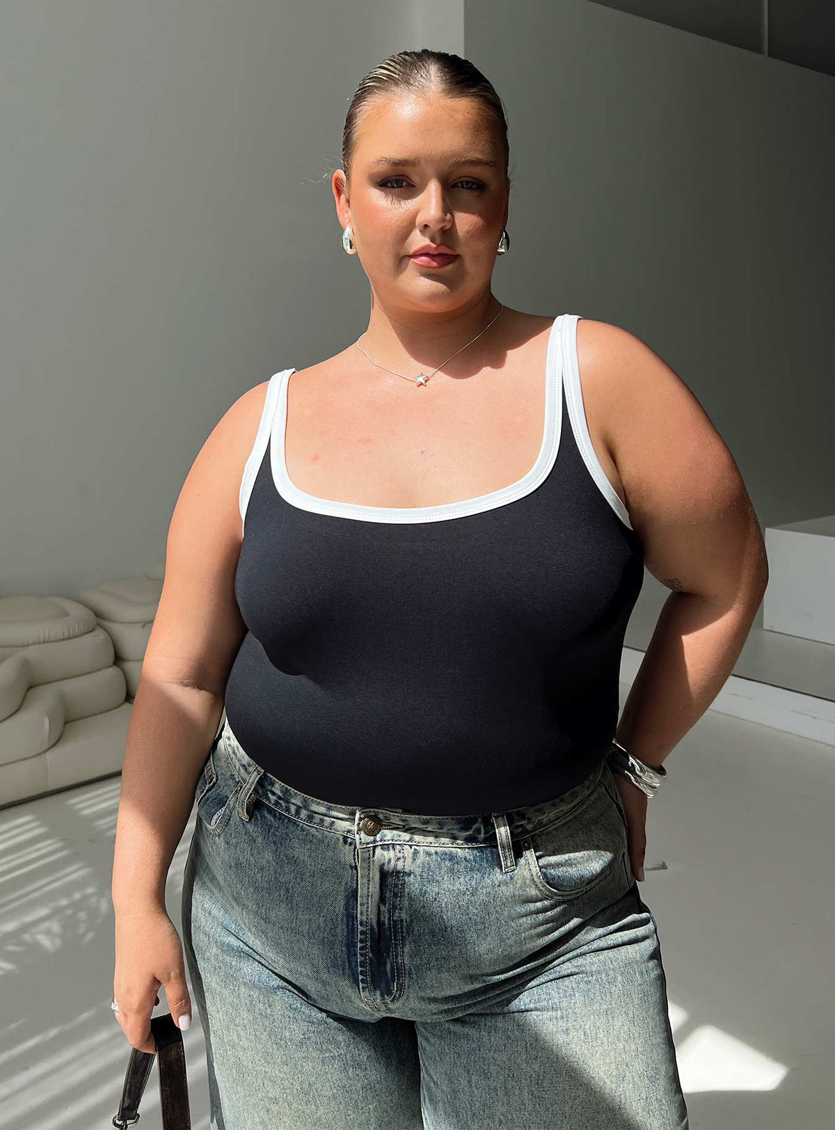 front view of model wearing Princess Polly Astrea Bodysuit Black / White Curve Sleeveless Bodysuit 