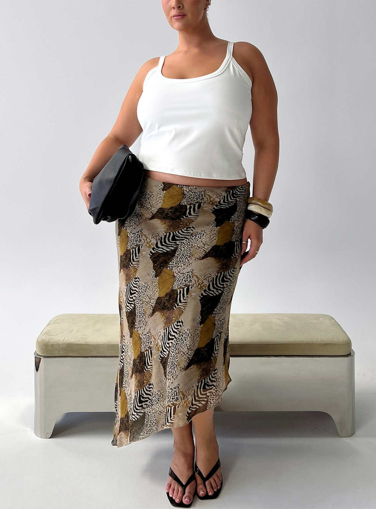 Showcasing the Suella Asymmetrical Midi Skirt Animal Multi Curve in womens-skirts with fitted silhouette and frayed hem in animal-leopard print front view of model wearing Princess Polly