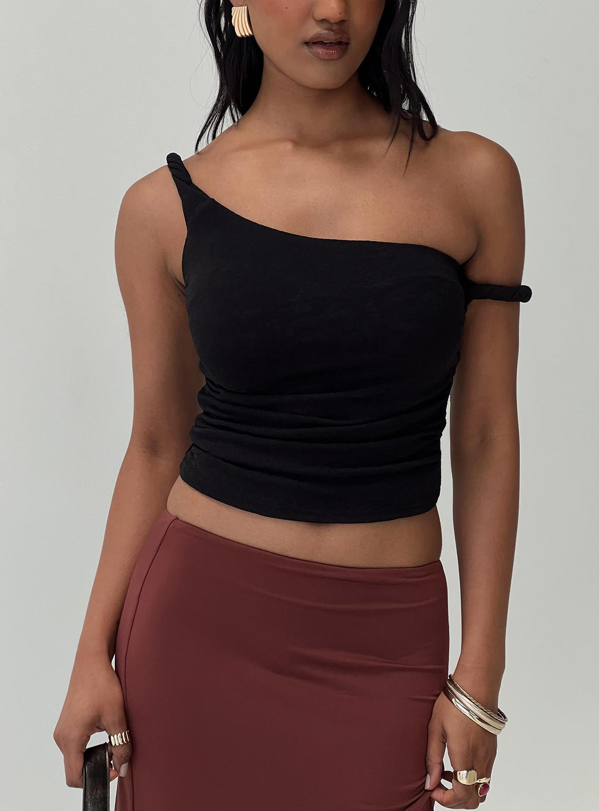front view of model wearing Princess Polly Messenger One Shoulder Top Black Sleeveless Asymmetric Neckline 