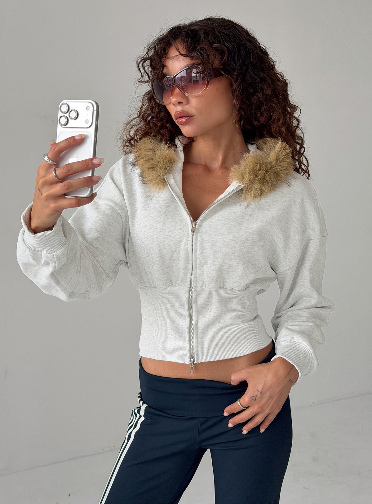 Discover the Ramonda Faux Fur Hooded Jumper in Grey Marle, a short womens jumper with oversized fit, front view of model wearing Princess Polly