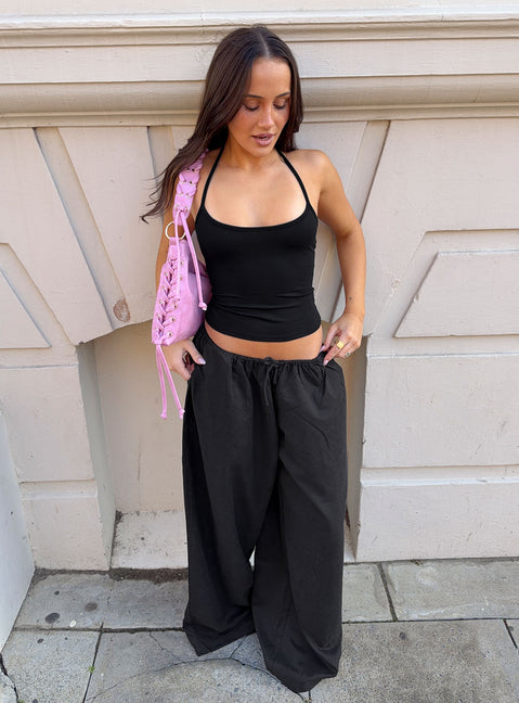 Showcasing the Bungala Oversized Relaxed Pants Black Tall wide-leg womens regular pants in mid-rise front view of model wearing Princess Polly