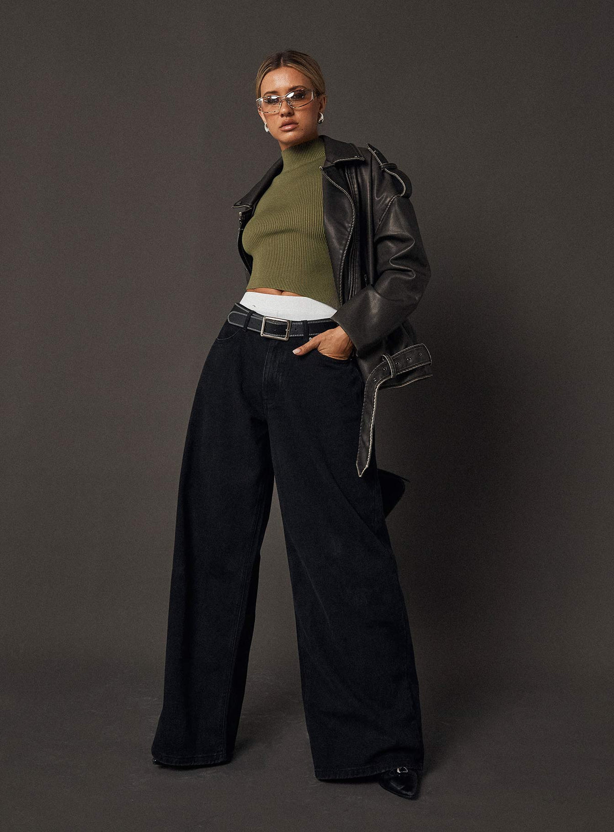 side view of model wearing Princess Polly Naylor Wide Leg Jeans Washed Black Denim Petite High Waisted 