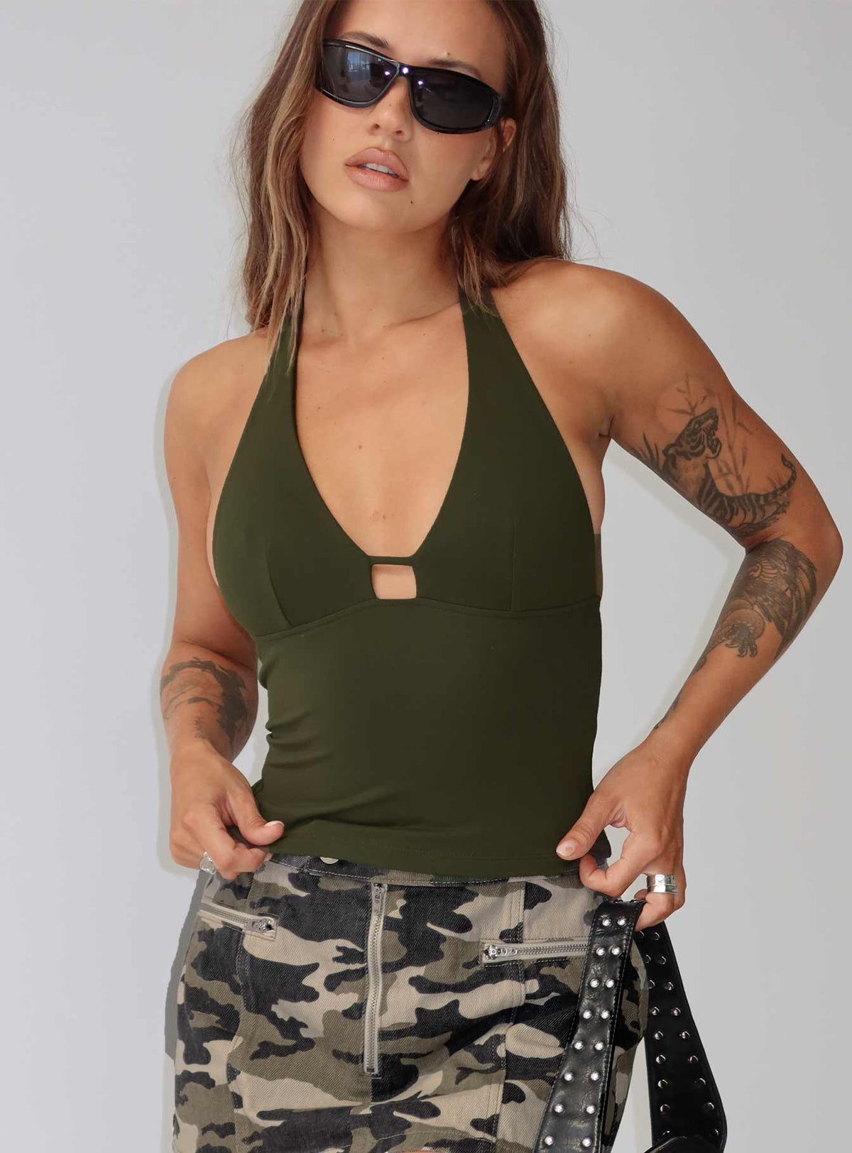 side view of model wearing Princess Polly Impress Me Halter Top Green Sleeveless Plunger 