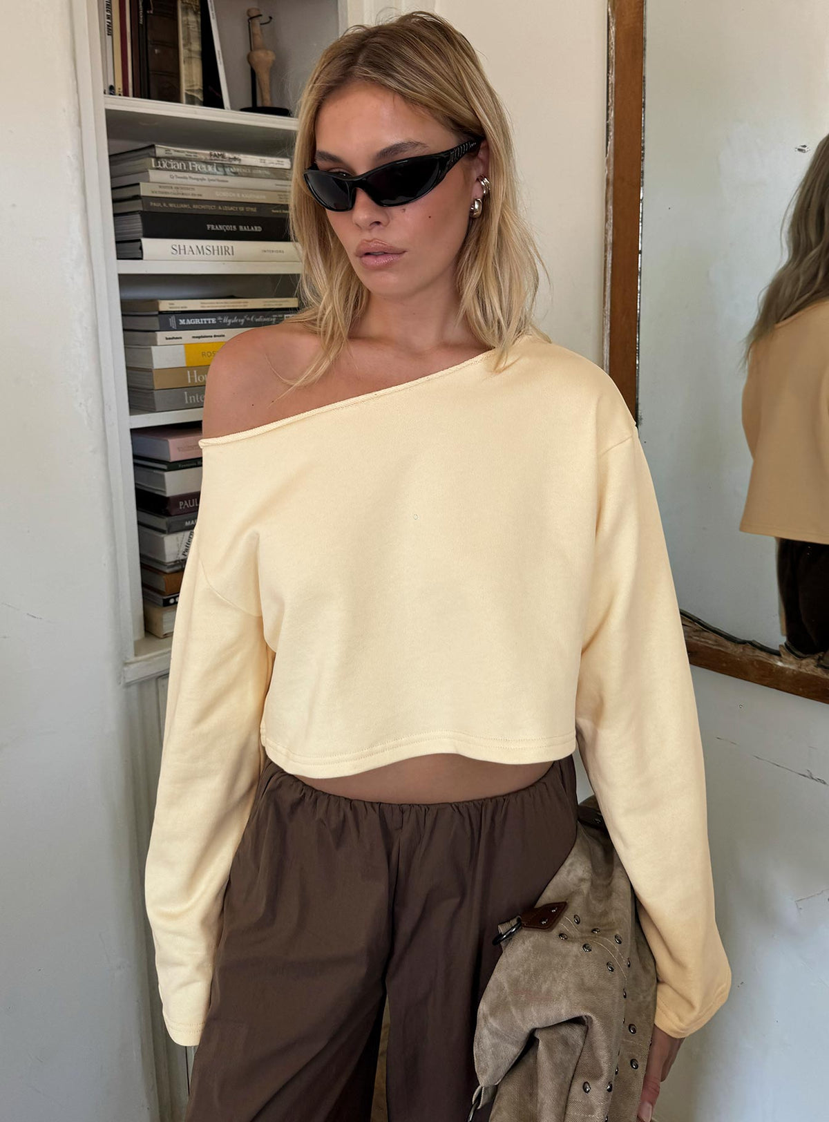 Showcasing the Retreat Raw Edge Off Shoulder Jumper Buttercream womens-jumpers with short length front view of model wearing Princess Polly