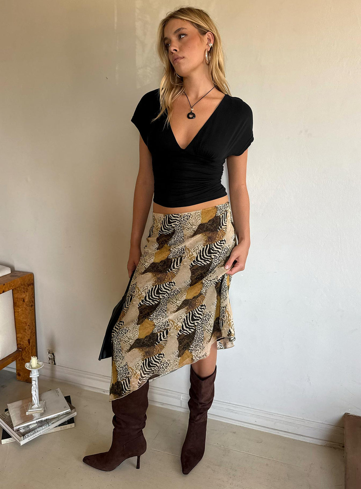 Featuring the Suella Asymmetrical Midi Skirt Animal Multi in womens skirts with relaxed fit, wrap design, and leopard print side view of model wearing Princess Polly