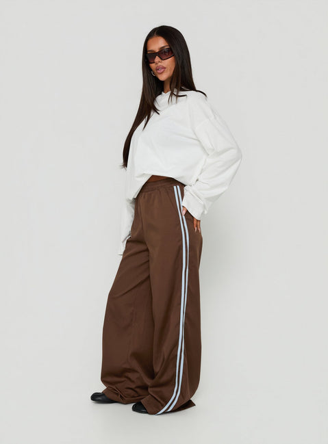 Showcasing the Fielder Track Pants Brown / Blue womens-regular-pants with high-rise side view of model wearing Princess Polly