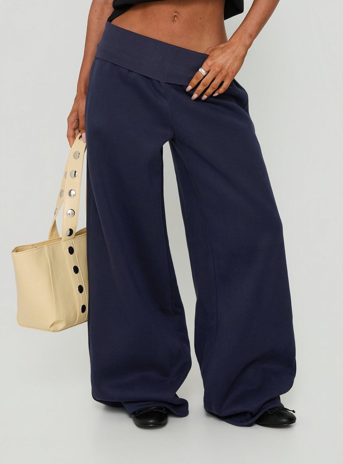 Showcasing the Lockie Foldover Baggy Track Pants Navy womens-regular-pants with low-rise front view of model wearing Princess Polly
