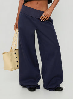 Showcasing the Lockie Foldover Baggy Track Pants Navy womens-regular-pants with low-rise front view of model wearing Princess Polly