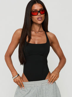 Showcasing the Ezekiel Bodysuit Black in sleeveless style with square halter neckline and thick straps, front view of model wearing Princess Polly