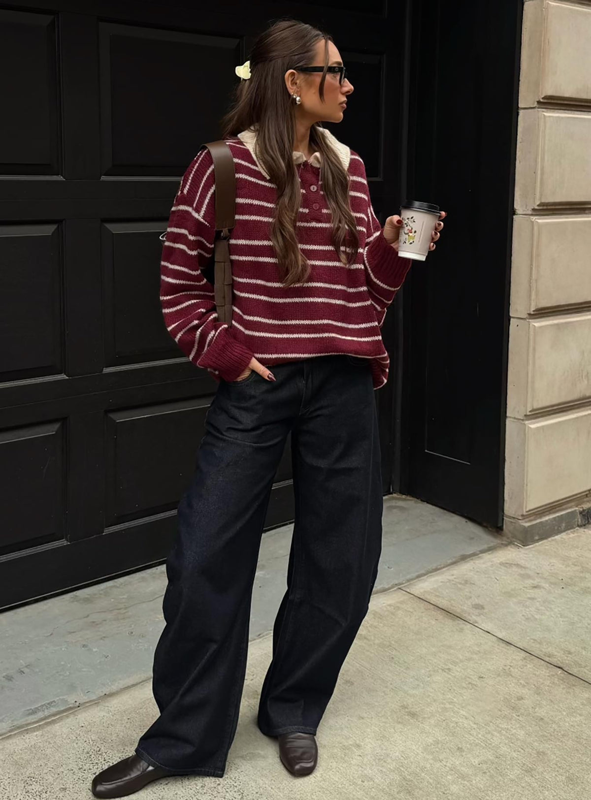 Showcasing the Rising Sun Jersey Crimson womens jumpers with long oversized fit, striped print, and v-neck collar side view of model wearing Princess Polly