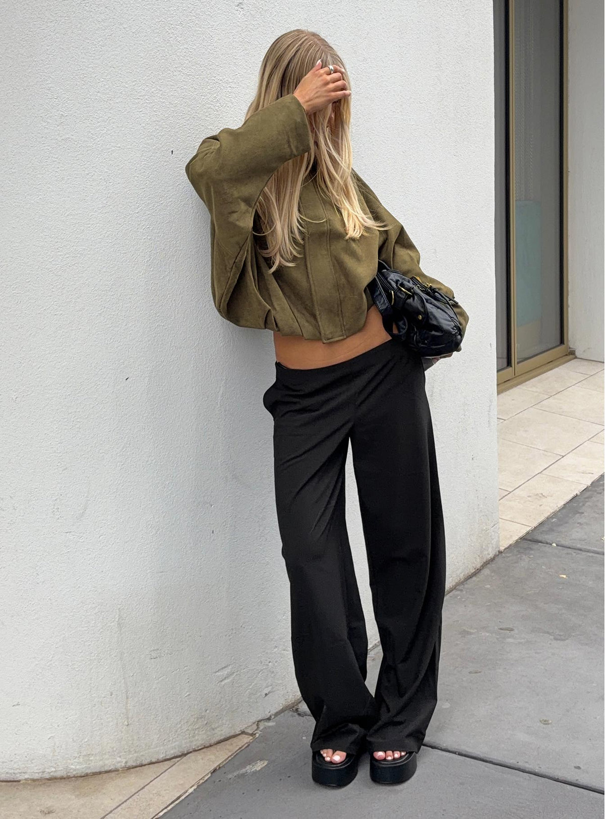 Featuring the Khane Low Rise Wide Leg Pant Black Tall in womens-regular-pants with low-rise waist front view of model wearing Princess Polly