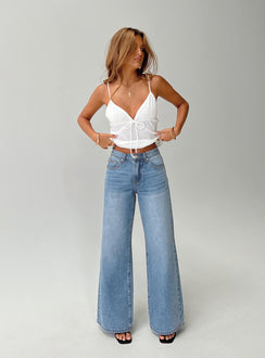 front view of model wearing Princess Polly Colemane Mid Rise Flared Jeans Angel Blue High Rise Jeans Jeans 