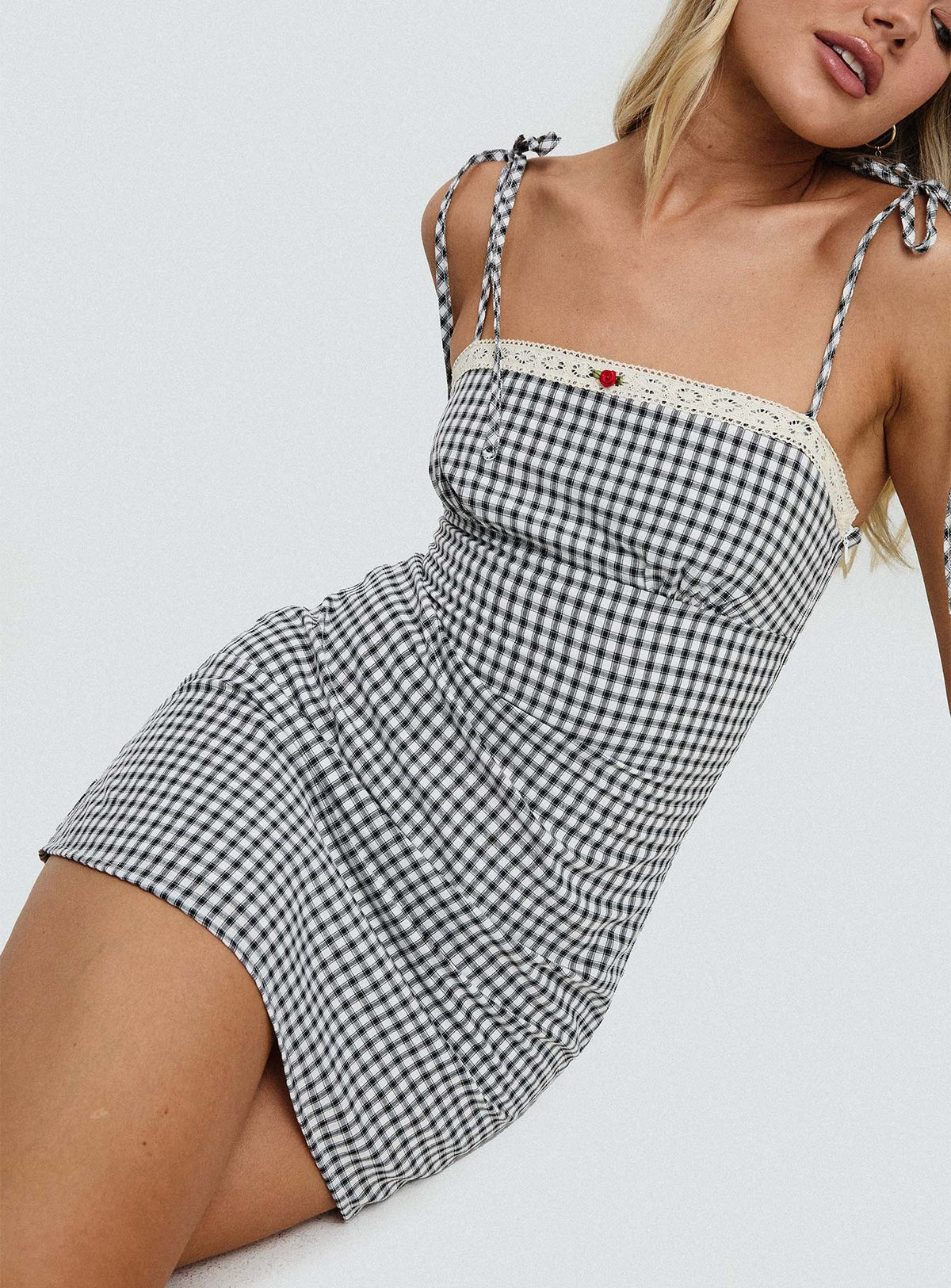 side view of model wearing Princess Polly Burkes Mini Dress Black Check Square Neck 
