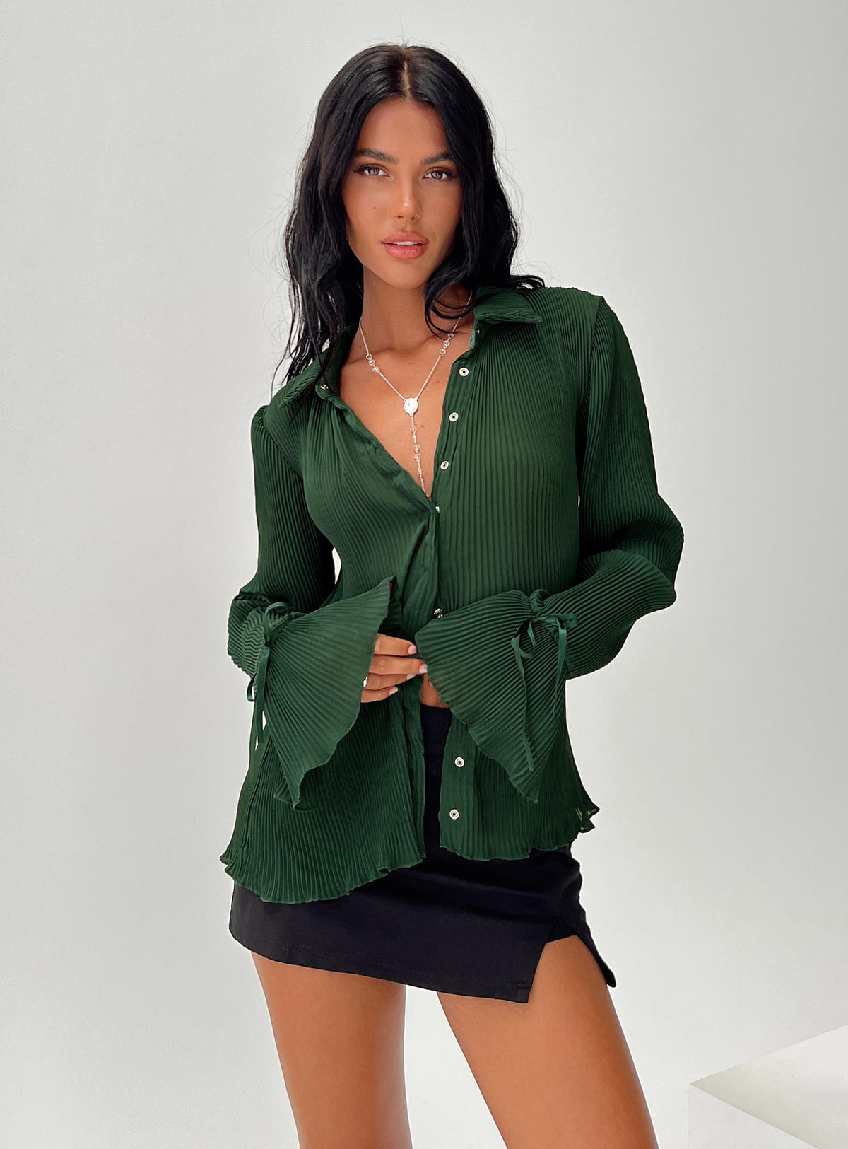 front view of model wearing Princess Polly Ravil Shirt Forest Green Full Sleeves V-Neck 