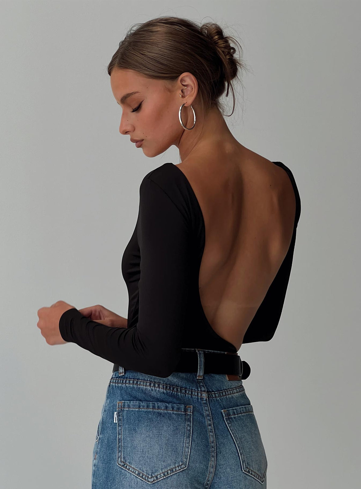 back view of model wearing Princess Polly Look This Good Backless Bodysuit Black Long Sleeve Tops Bodysuit 