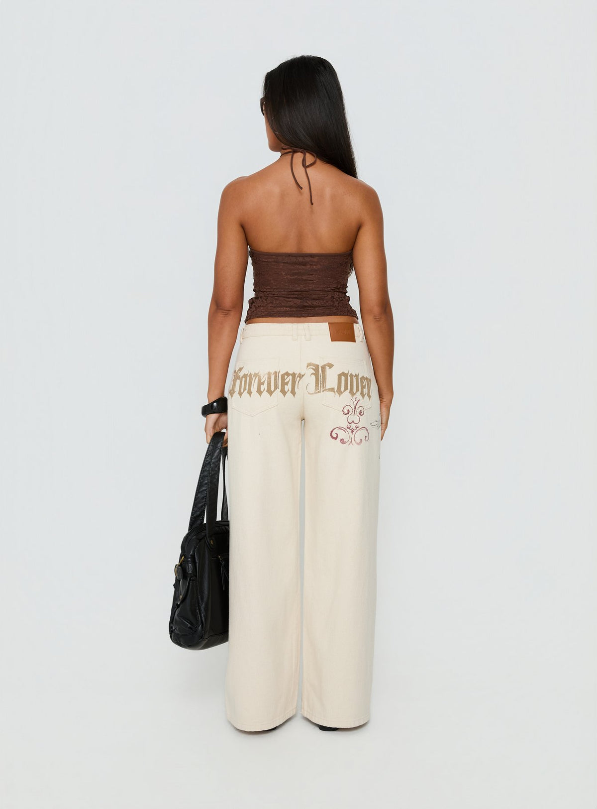 back view of model wearing Princess Polly Than Forever Love Graphic Denim Jeans Cream Low Rise Jeans Jeans 