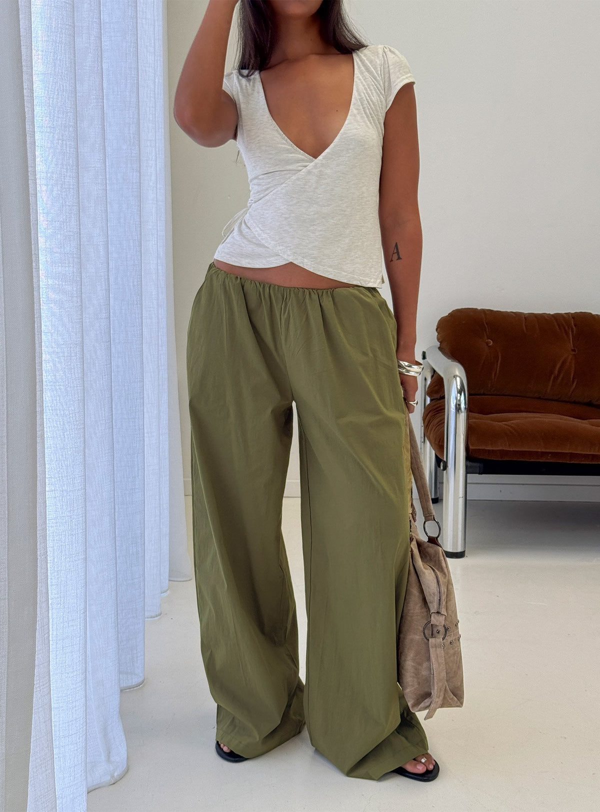 Featuring the Lunea Concealed Waistband Pants Khaki womens-regular-pants with high-rise front view of model wearing Princess Polly