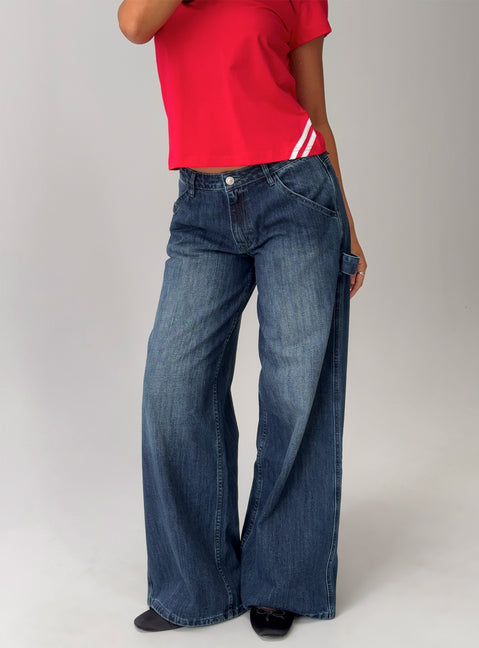 side view of model wearing Princess Polly Downtowner Low Rise Cargo Jeans Mid Blue Wash Low Rise Jeans Jeans 