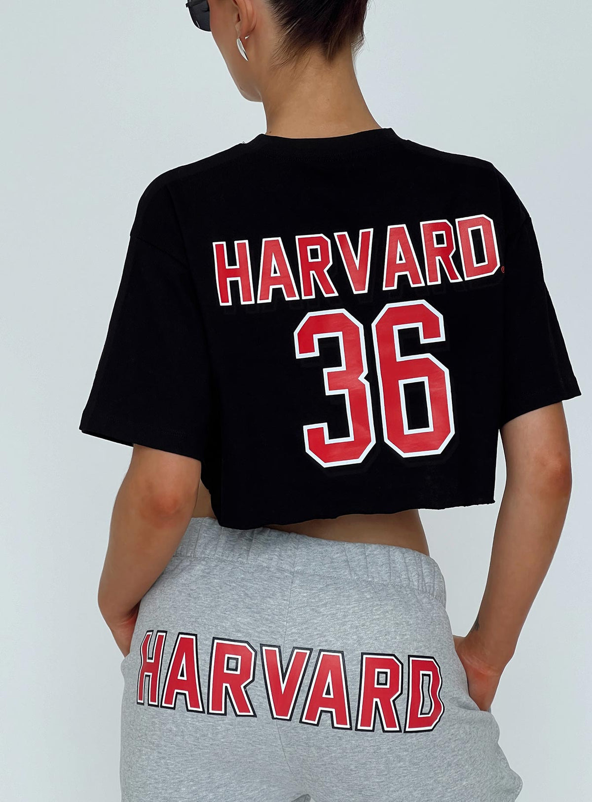 back view of model wearing Princess Polly Harvard Graphic Track Top Black Short Sleeves Crew Neck 