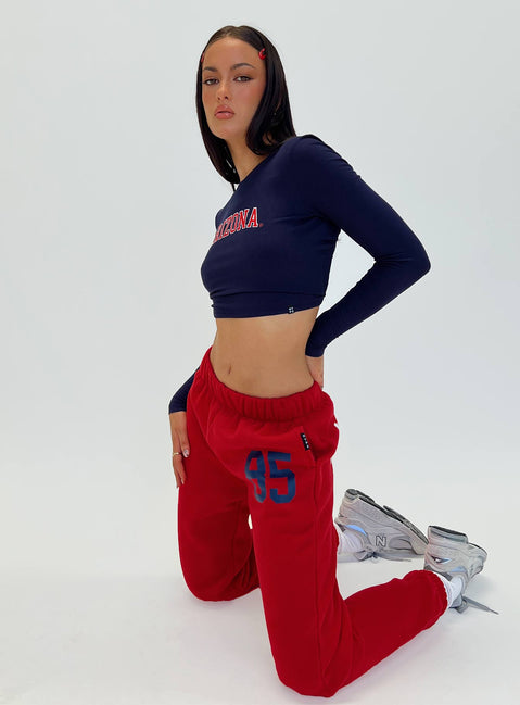 Featuring U of A Sweatpants Red in womens regular pants with mid-rise and graphic print, side view of model wearing