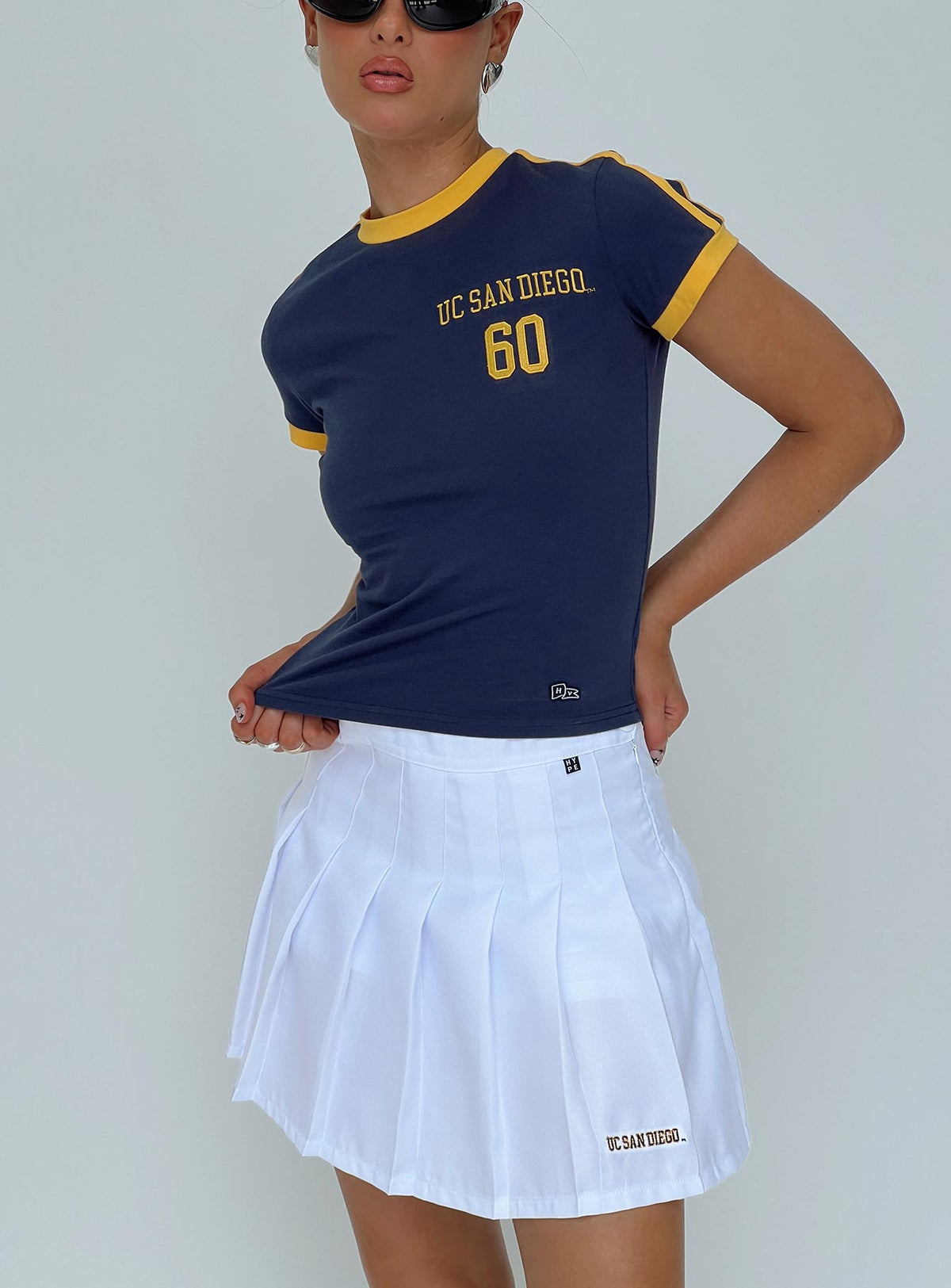 back view of model wearing Princess Polly UCSD Goalie Baby Tee Navy Short Sleeves Crew Neck 
