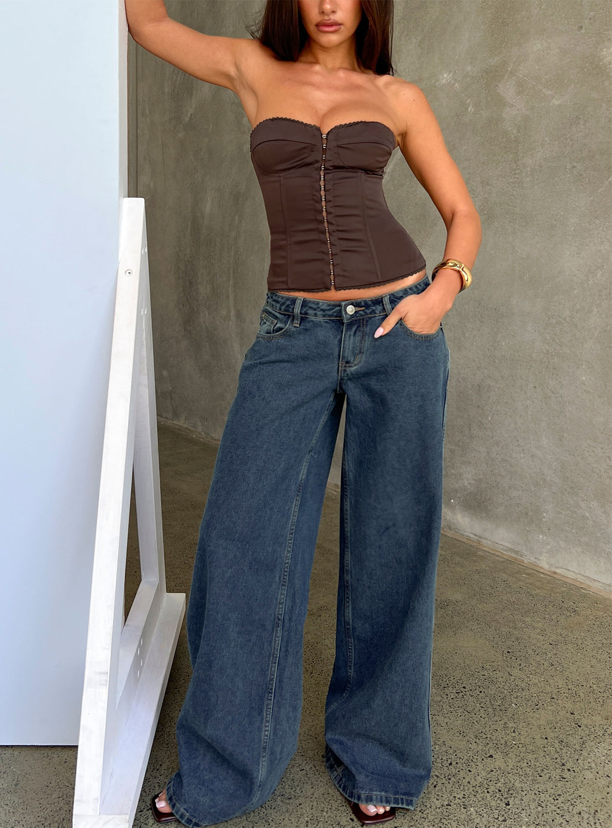 Showcasing the Picco Ultra Low Rise Wide Leg Jeans Dark Blue Wash Petite in womens-jeans with low-rise waist front view of model wearing Princess Polly