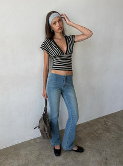 Showcasing the Flow Rider No Waist Low Rise Bootleg Jean Vintage Blue Wash womens-jeans with low-rise waist front view of model wearing Princess Polly