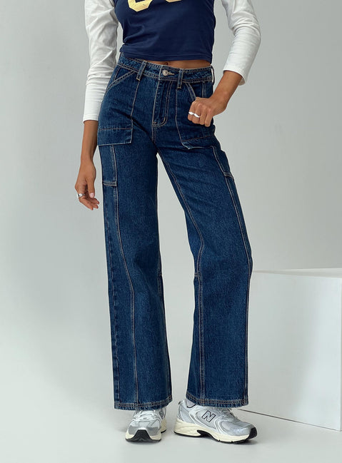 side view of model wearing Princess Polly Chad High Rise Wide Leg Cargo Jeans Dark Wash Denim Mid Rise Jeans Jeans 