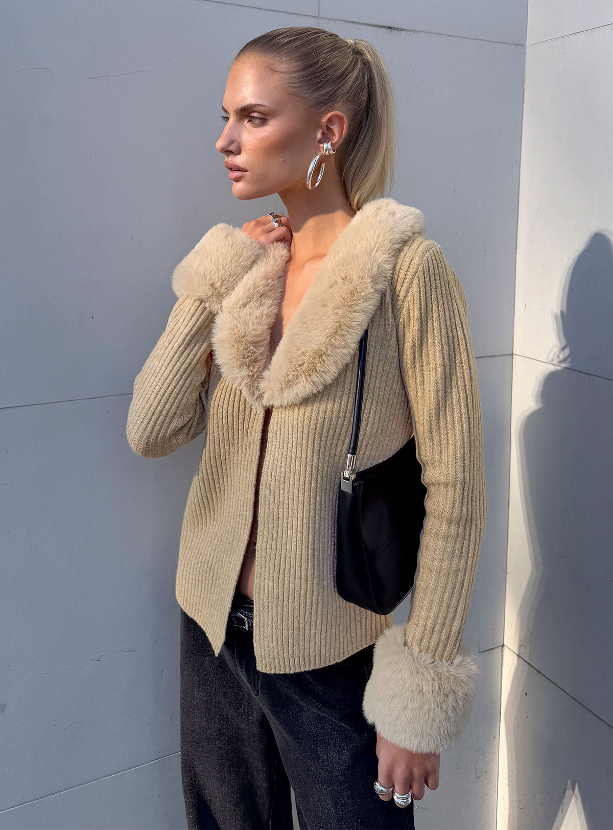 Showcasing the Gisele Faux Fur Trim Long Sleeve Sand womens jumpers with short length side view of model wearing Princess Polly