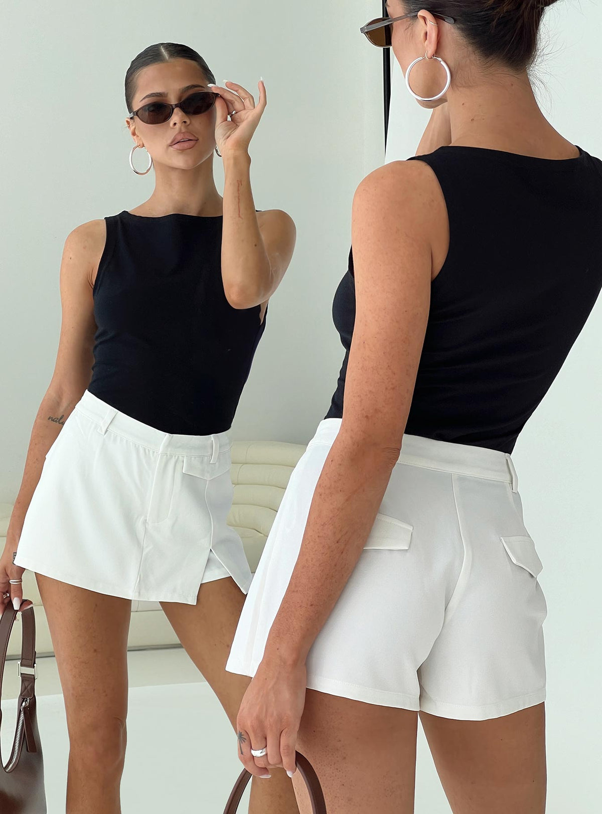 side view of model wearing Princess Polly Deuce Split Skort White High Waisted Shorts 
