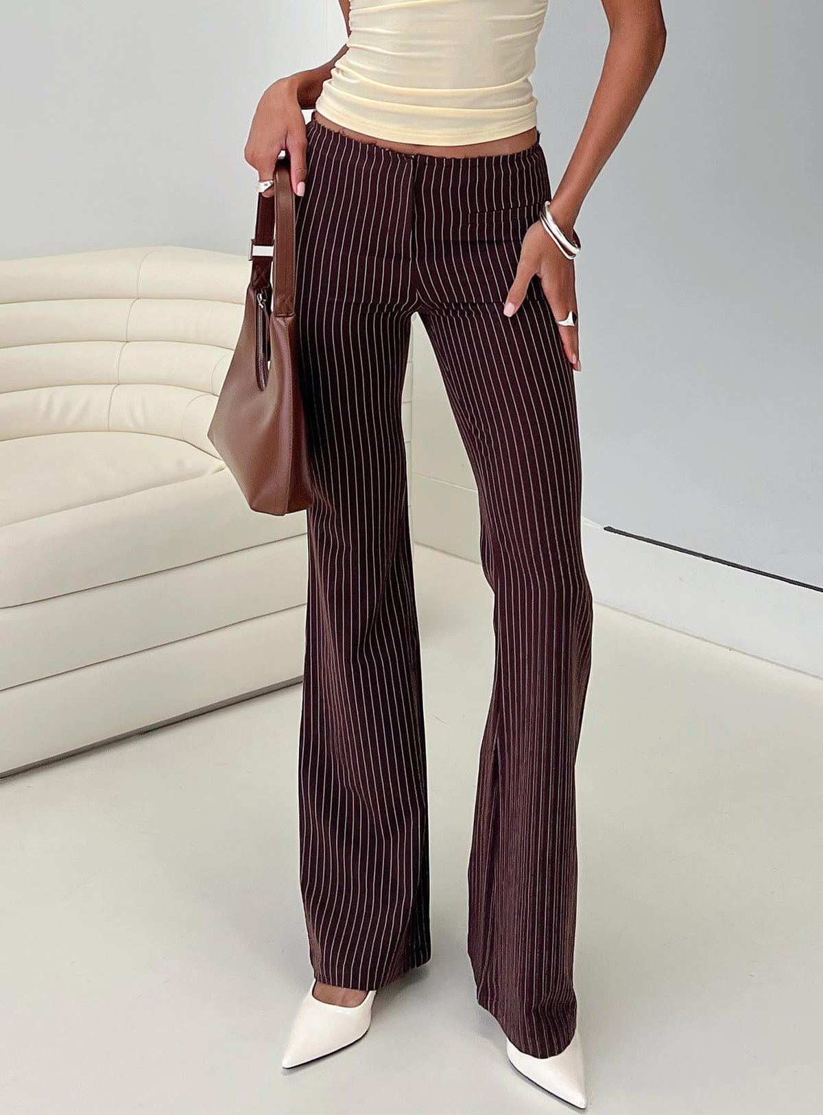 side view of model wearing Princess Polly Sportia Flare Pants Brown High Waisted Pants 