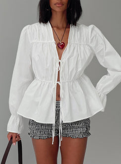 front view of model wearing Princess Polly Scarlotte Bow Tie Top White Full Sleeves V-Neck 