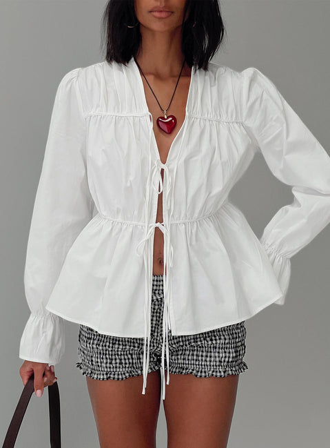 front view of model wearing Princess Polly Scarlotte Bow Tie Top White Full Sleeves V-Neck 