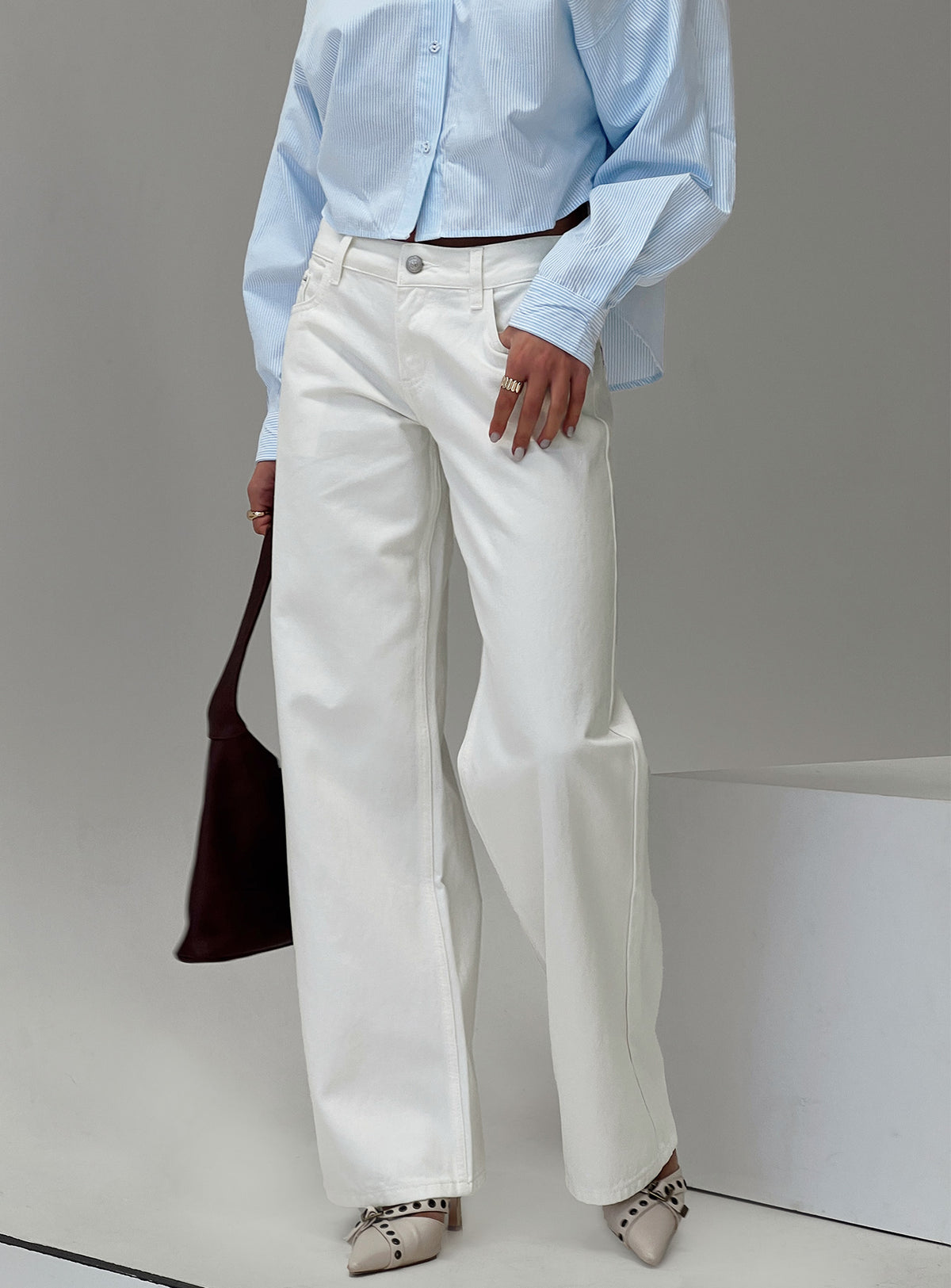 side view of model wearing Princess Polly Ellanor Low Rise Straight Leg Jeans White Mid Rise Jeans 