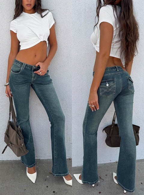 Crafted from low-rise denim, the Clynee Ultra Low Rise Bootleg Jeans Dirty Blue in womens-jeans front view of model wearing Princess Polly