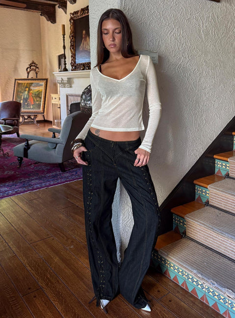 Showcasing the Daydream Tie Up Jeans in Dark Denim womens-jeans with low-rise front view of model wearing Princess Polly