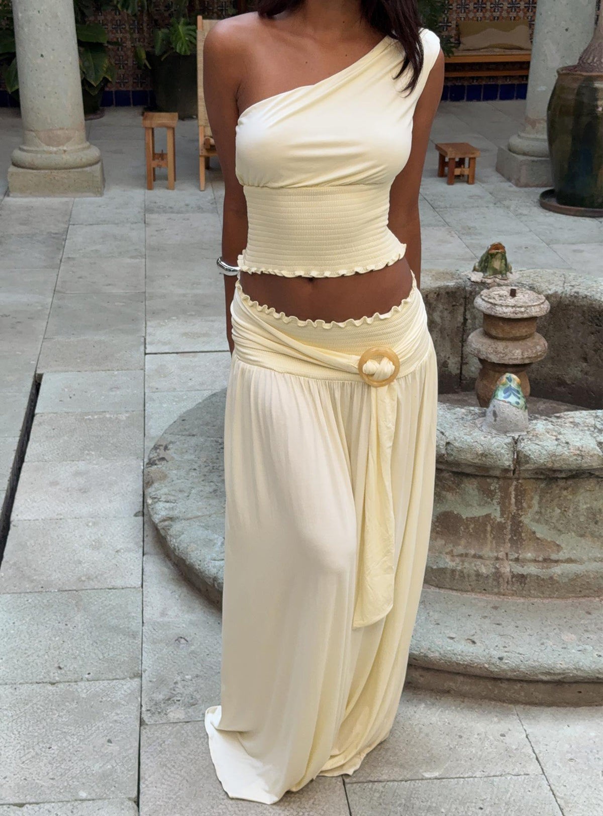   side view of model wearing Princess Polly Full Orbit Shirred Maxi Skirt Cream Maxi Skirts Skirts 