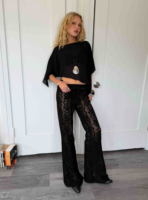 Featuring Rosadonna Lace Flare Pants Black in womens regular pants with mid-rise front view of model wearing Princess Polly