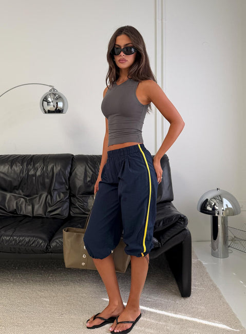 Showcasing the Riyah 3/4 Low Rise Nylon Pants Navy in womens-regular-pants with striped detail front view of model wearing Princess Polly