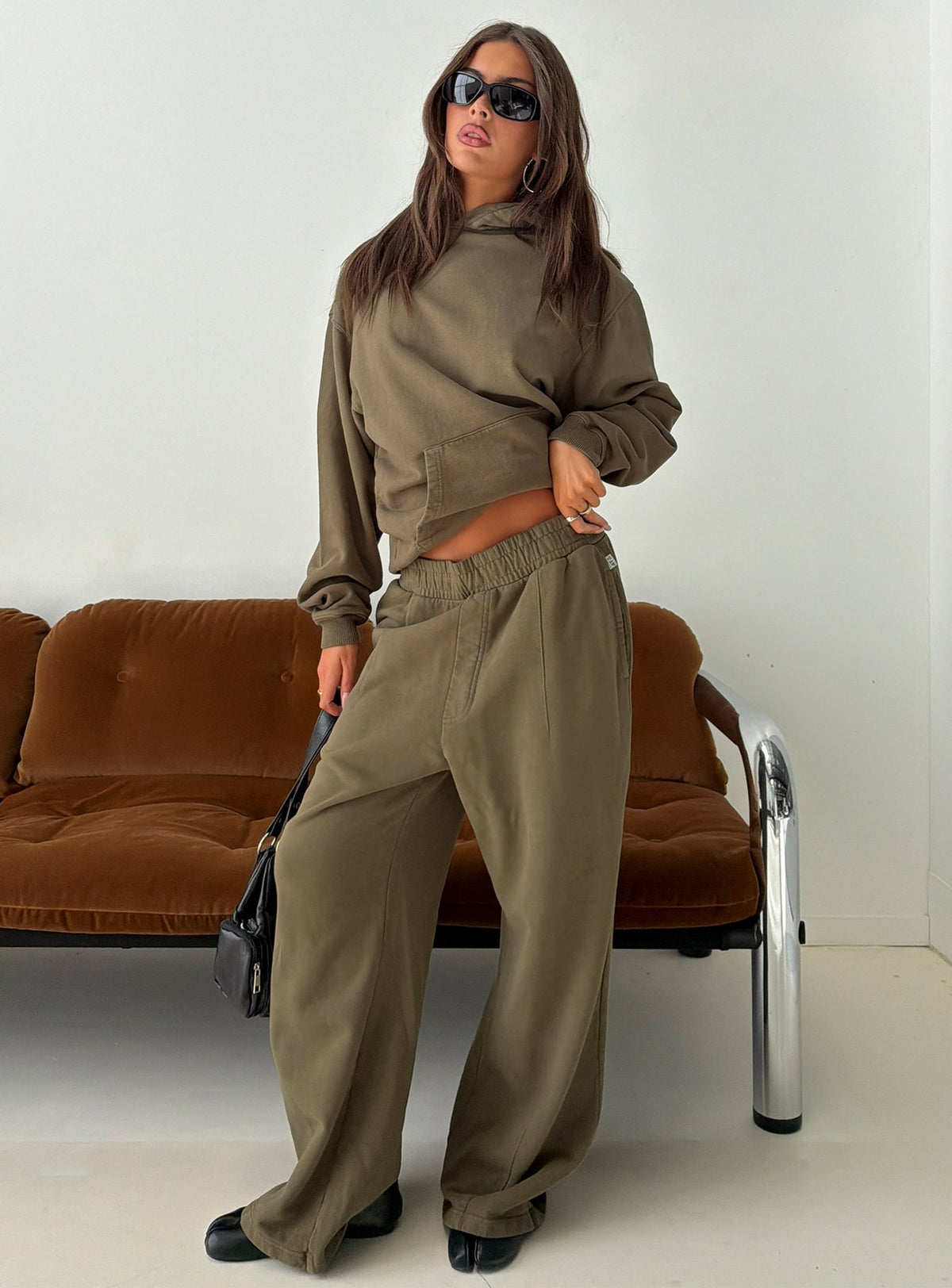 Showcasing the AT Fleece Baggy Sweatpant Washed Olive in womens-regular-pants with mid-rise wide-leg styling front view of model wearing Princess Polly