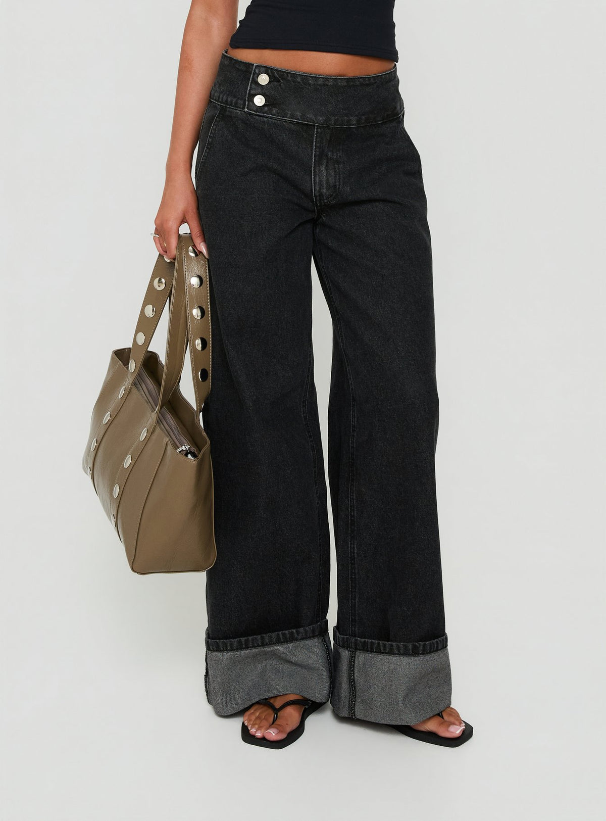 Showcasing the Nikoletta Foldover Jeans Washed Black in high-rise wide-leg style Princess Polly