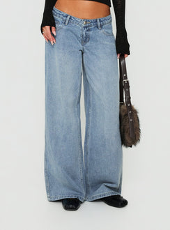 Showcasing Picco Ultra Low Rise Wide Leg Jeans Light Blue Wash Petite in womens-jeans with a low-rise waist view of model wearing Princess Polly