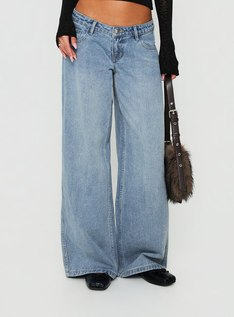 Showcasing Picco Ultra Low Rise Wide Leg Jeans Light Blue Wash Petite in womens-jeans with a low-rise waist view of model wearing Princess Polly