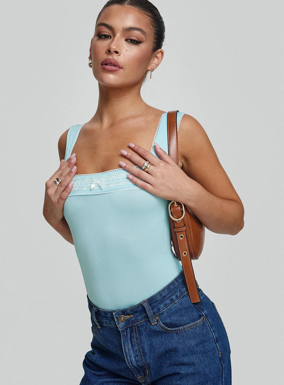 side view of model wearing Princess Polly Keating Bodysuit Baby Blue Sleeveless Bodysuit 