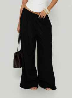 Showcasing Peacemaker Tie Waist Relaxed Pants Black in womens-regular-pants with mid-rise detail front view of model wearing
