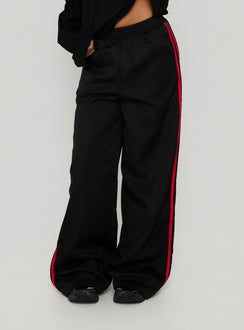Featuring Fielder Track Pants Black / Red in womens-regular-pants with mid-rise front view of model wearing