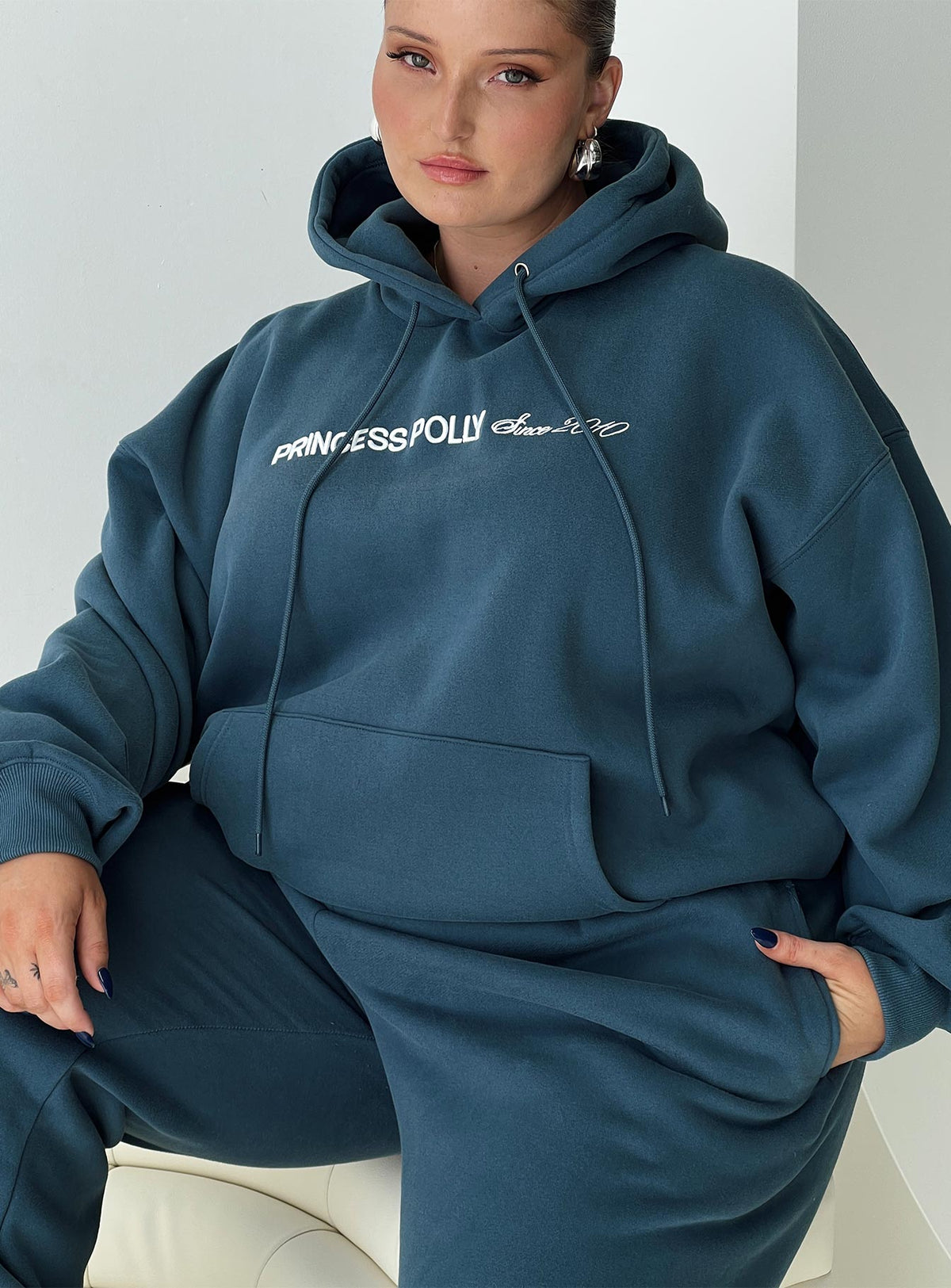 front view of model wearing Princess Polly Princess Polly Hooded Sweatshirt Block / Cursive Text Slate Curve Jumpers 
