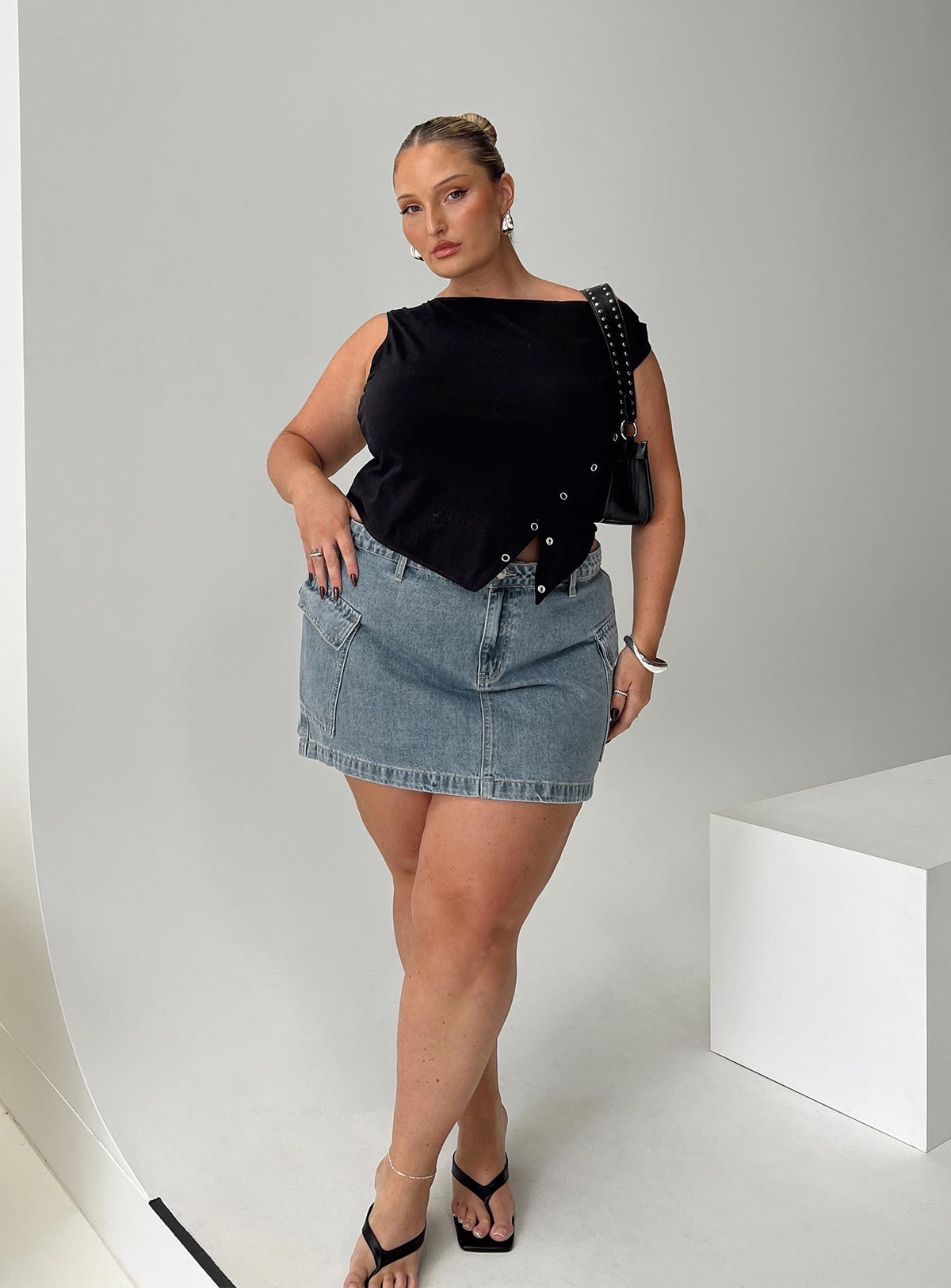   side view of model wearing Princess Polly Zakai Cargo Denim Mini Skirt Light Blue Denim Curve Mini Skirts Skirts 