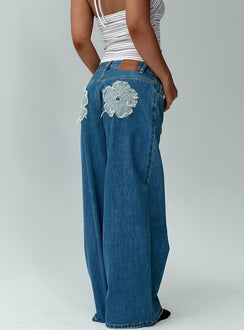 back view of model wearing Princess Polly A Keeper Flower Patch Low Rise Wide Leg Jeans Mid Blue Low Rise Jeans Jeans 