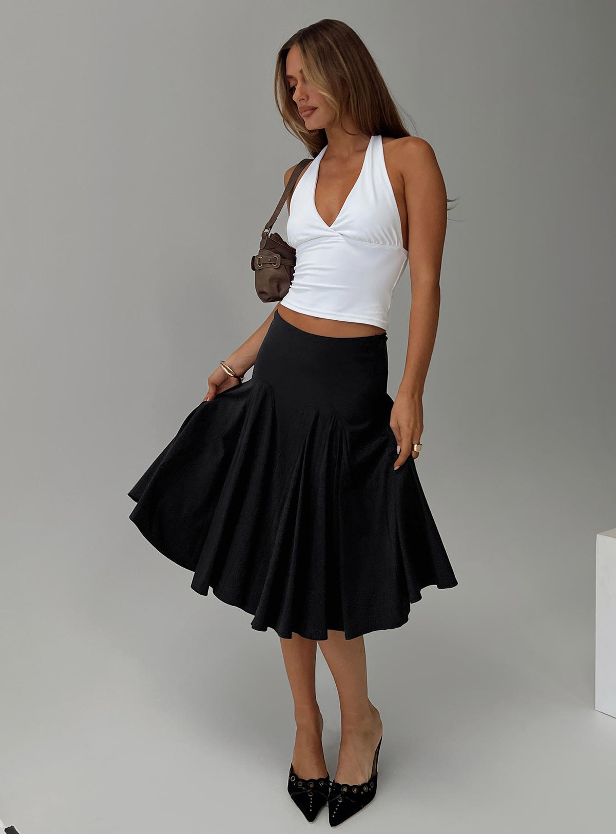   side view of model wearing Princess Polly Agnette Low Rise Midi Skirt Black 